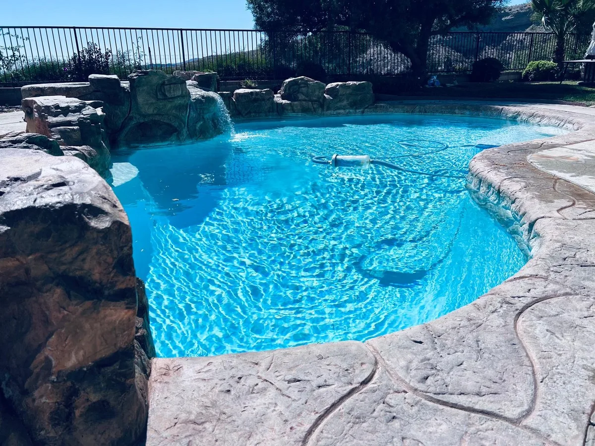 Rock pool with a waterfall feature and clear water