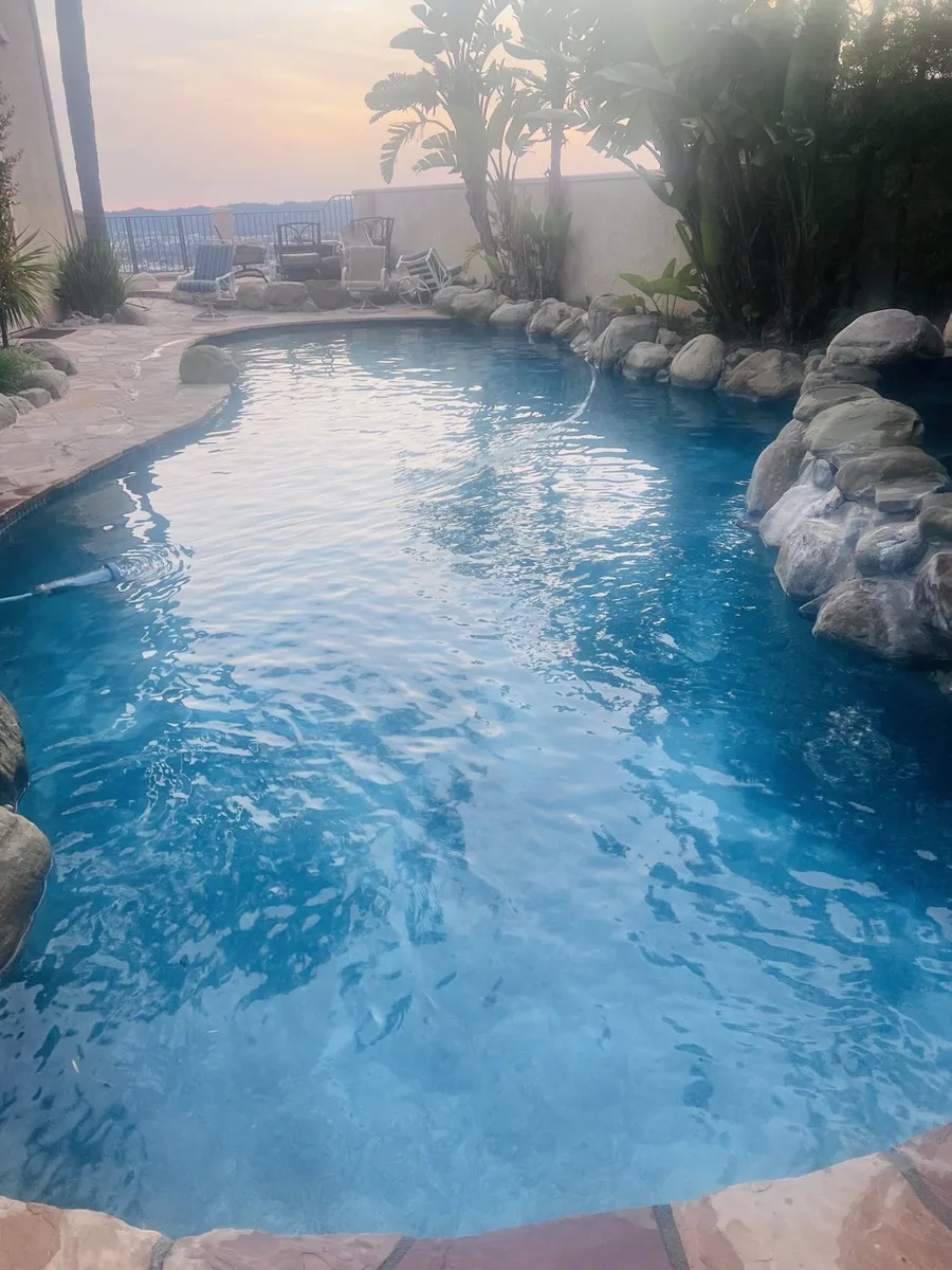 Clear pool beside natural rockwork