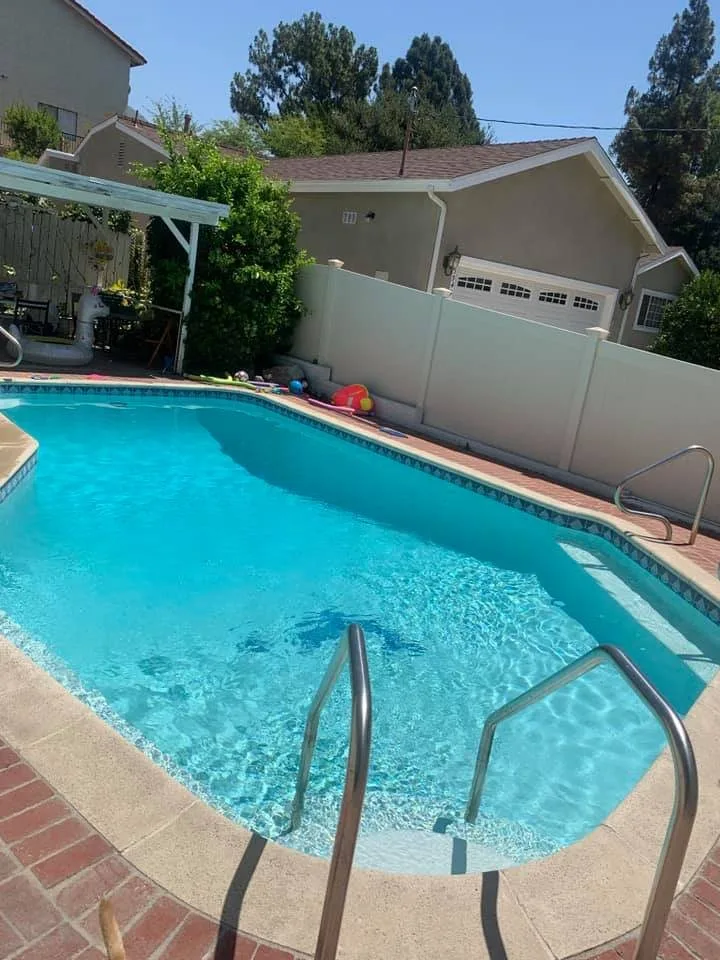 Clear pool with a stainless steel entry rail